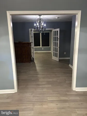 a view of a hallway with a chandelier