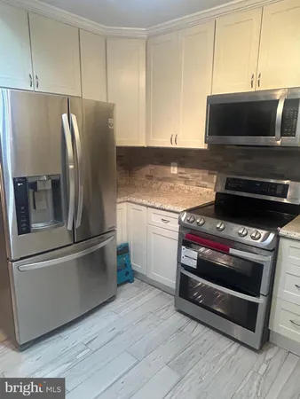 a kitchen with appliances and cabinets