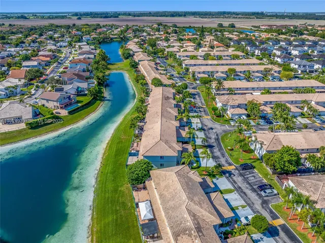 an aerial view of a tennis ground and a yard