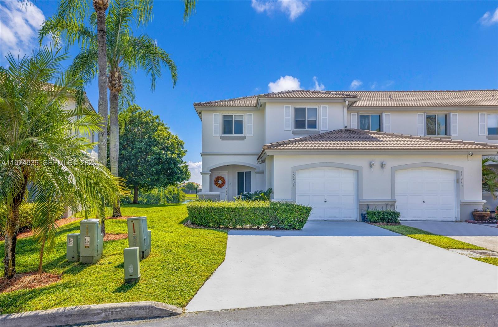 16236 Southwest 75th Street Miami, FL 33193 - Photo 2 of 53 a front view of a house with a yard and garage