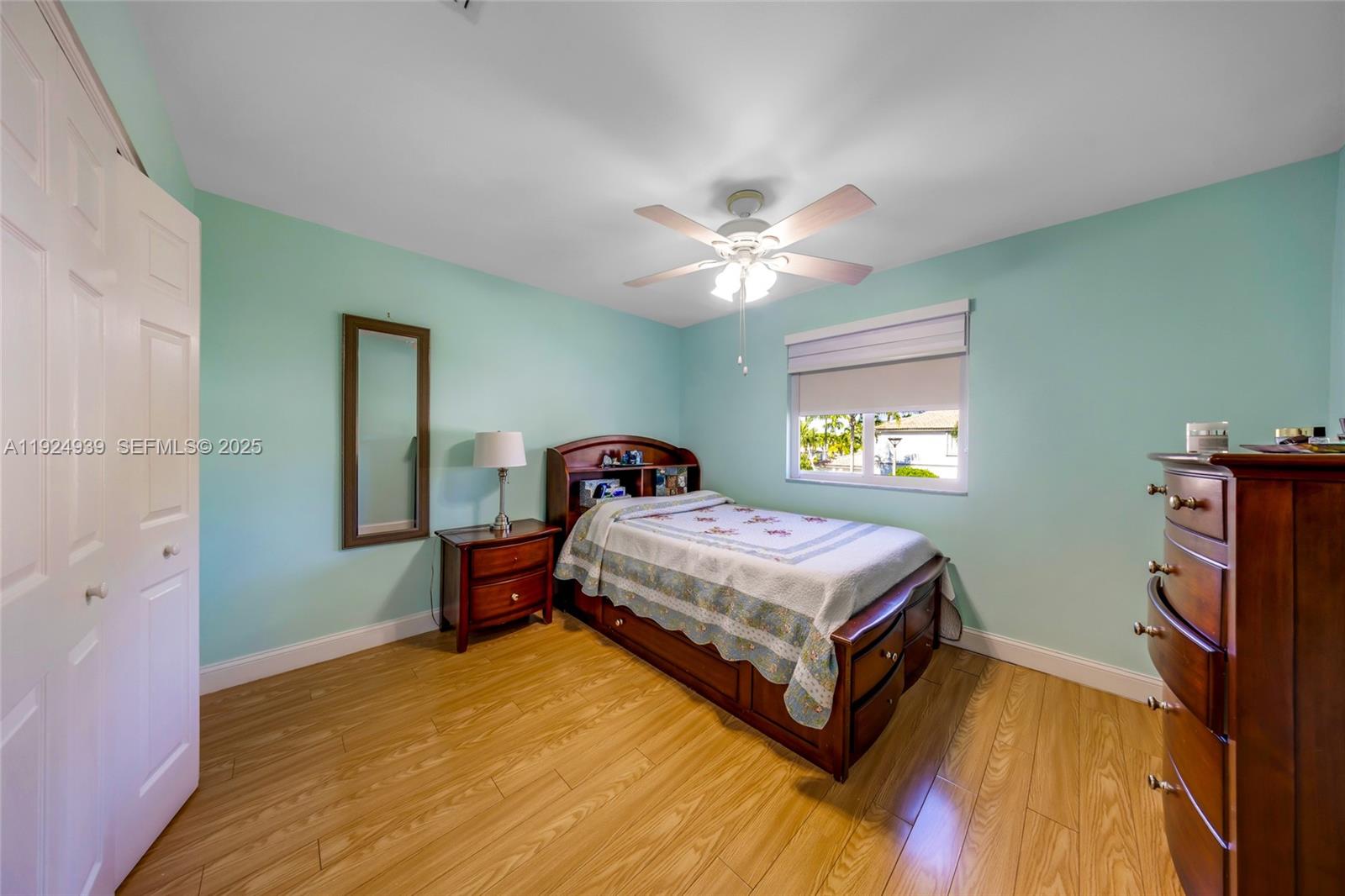 16236 Southwest 75th Street Miami, FL 33193 - Photo 22 of 53 a bedroom with a bed and a chandelier
