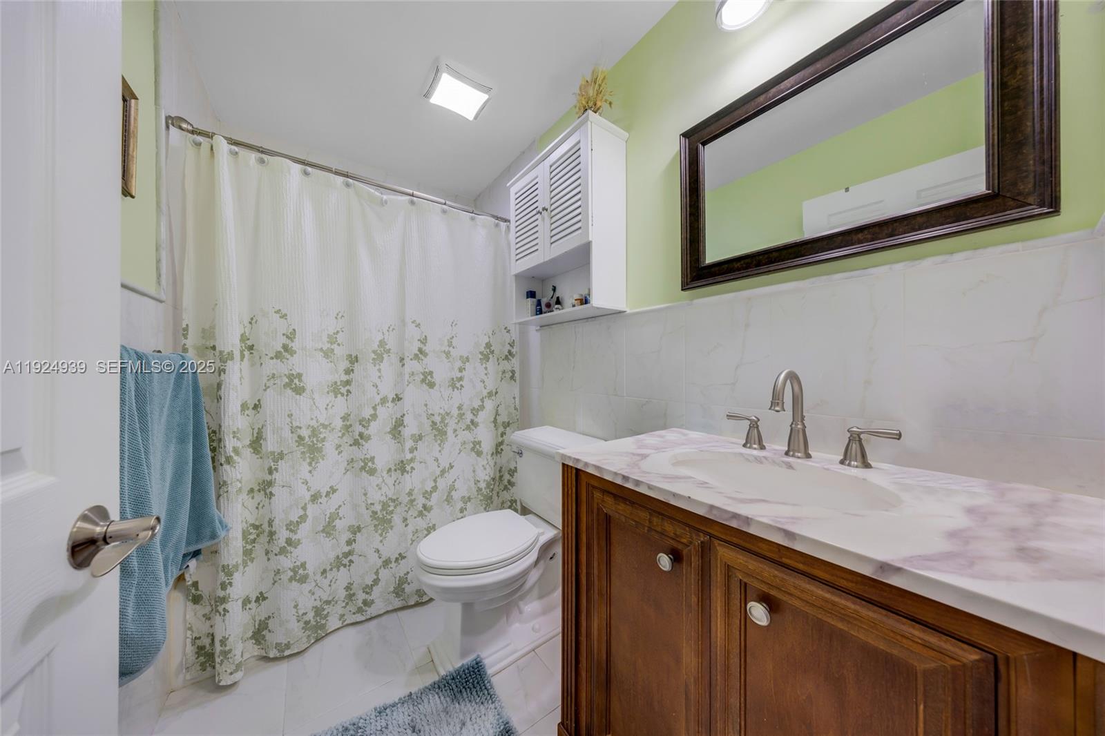 16236 Southwest 75th Street Miami, FL 33193 - Photo 25 of 53 a bathroom with a granite countertop sink toilet and mirror
