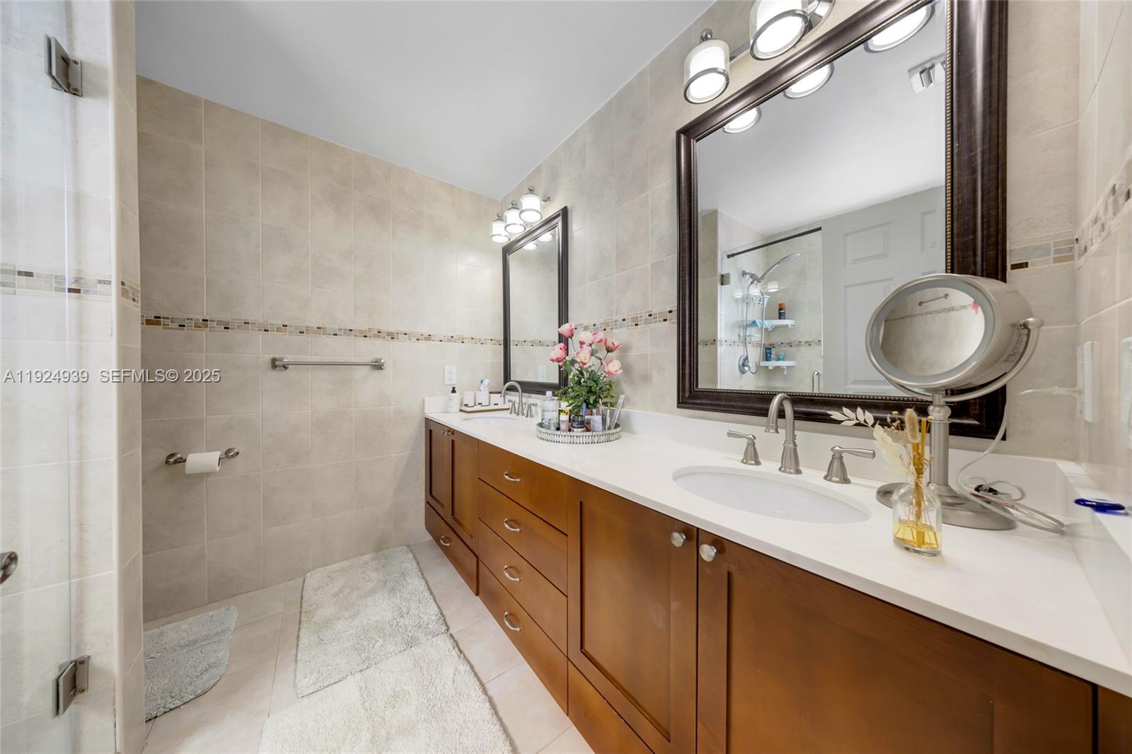 16236 Southwest 75th Street Miami, FL 33193 - Photo 27 of 53 a bathroom with a double vanity sink mirror and shower