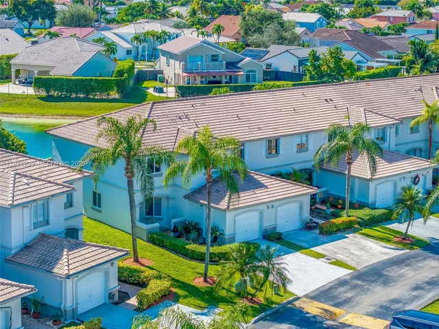 a aerial view of a house with swimming pool garden and patio
