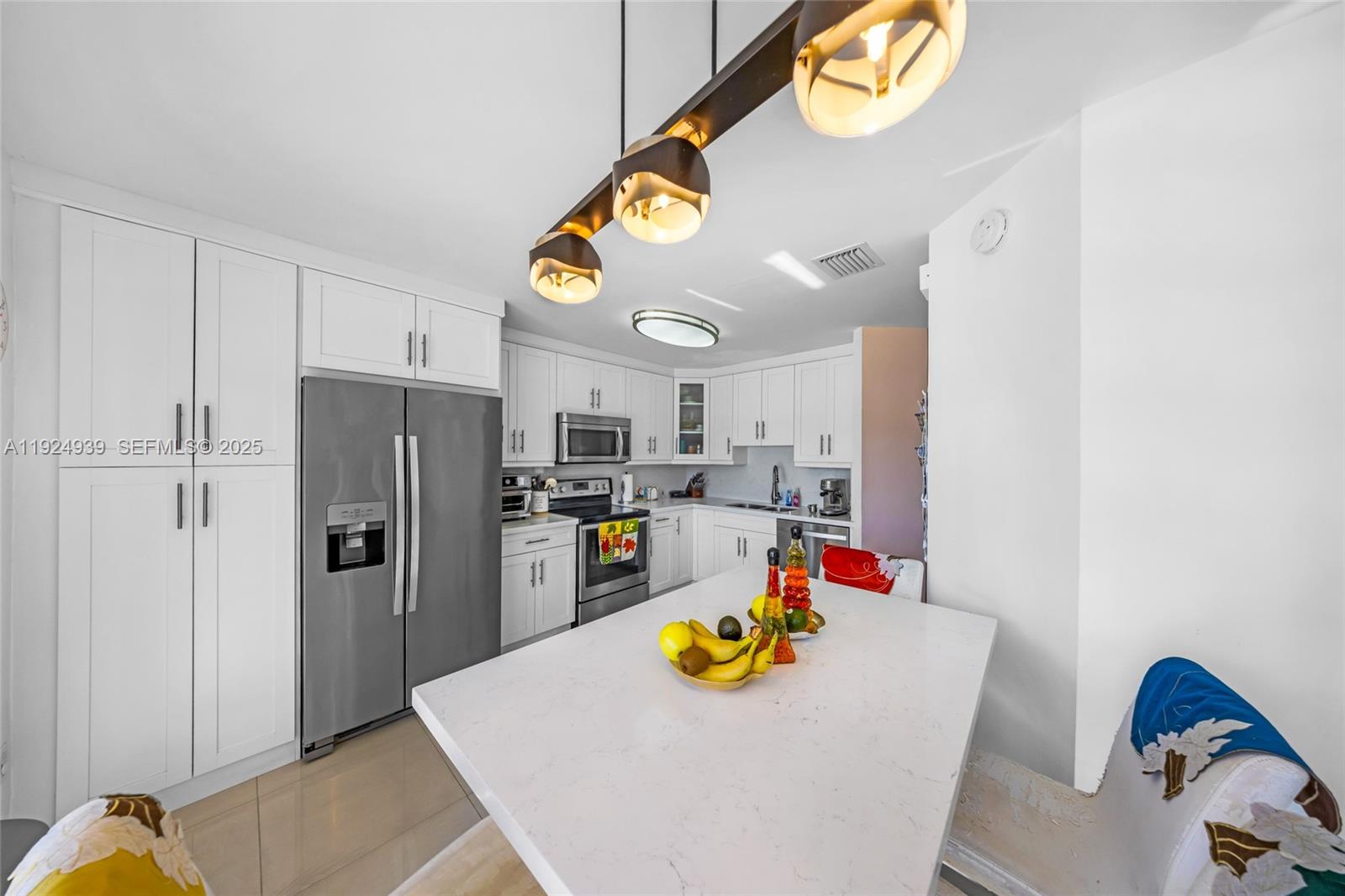 16236 Southwest 75th Street Miami, FL 33193 - Photo 37 of 53 a kitchen with stainless steel appliances granite countertop a sink and a refrigerator