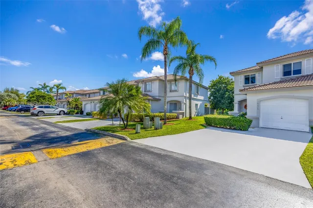 a view of a house with swimming pool and a yard