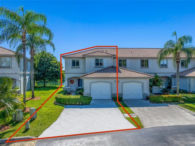 a front view of house with yard and green space