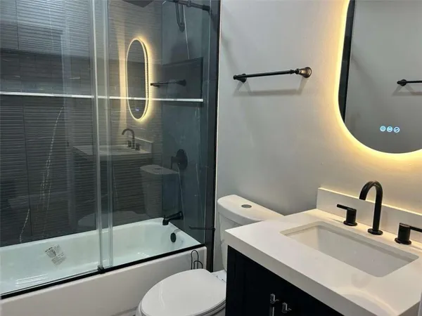 a bathroom with a sink toilet and shower