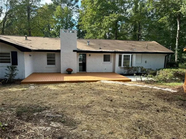 a view of a house with pool and yard