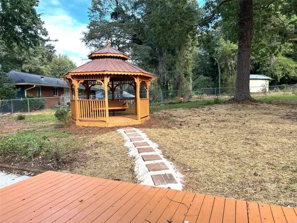 a backyard of a house with barbeque oven