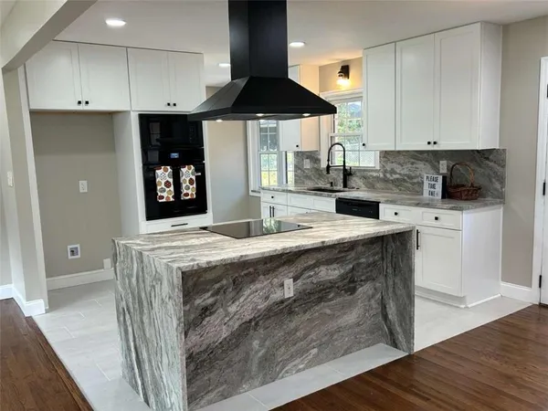 a kitchen with a stove a sink and a refrigerator