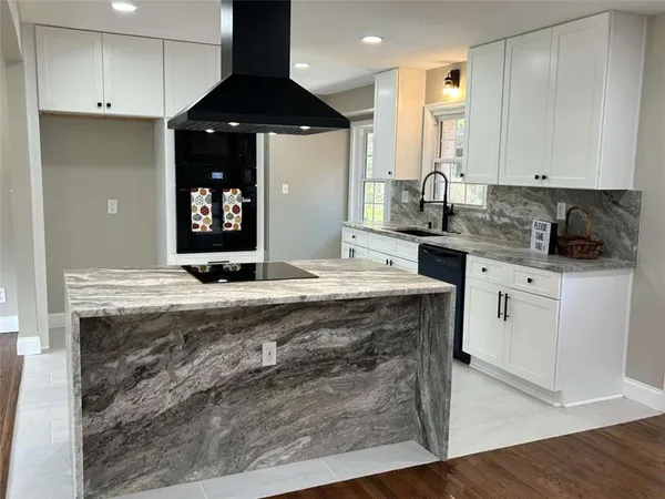 a kitchen with a sink stove and cabinets