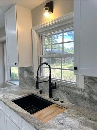 a kitchen with a sink a counter top space and a window