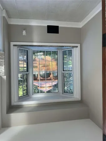 a living room with a large window and front door