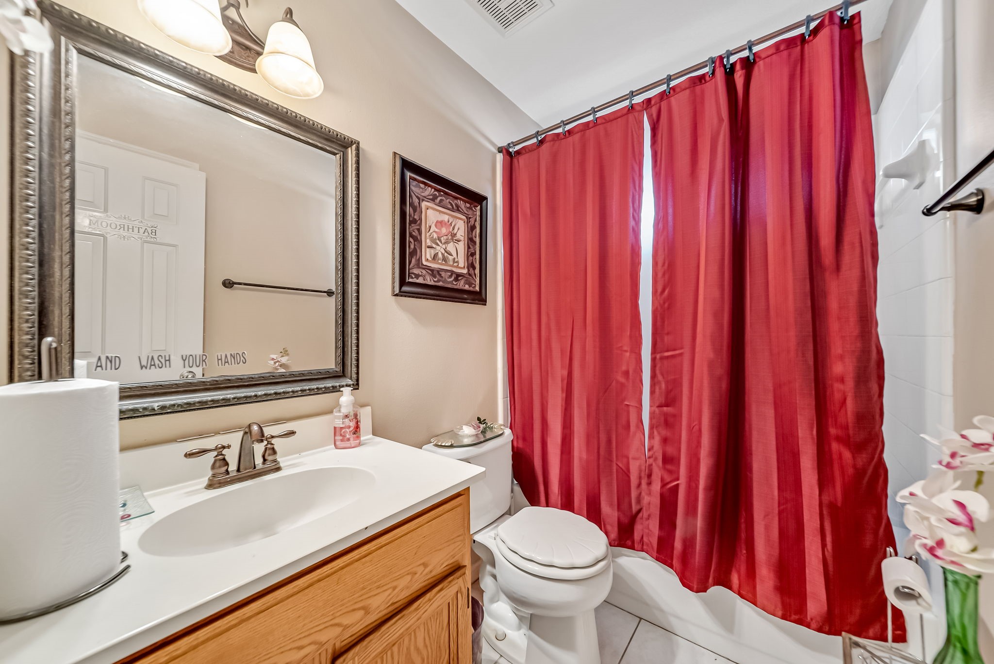 22906 Prairie Bird Lane Spring, TX 77373 - Photo 4 of 14 a bathroom with a sink a toilet and a mirror