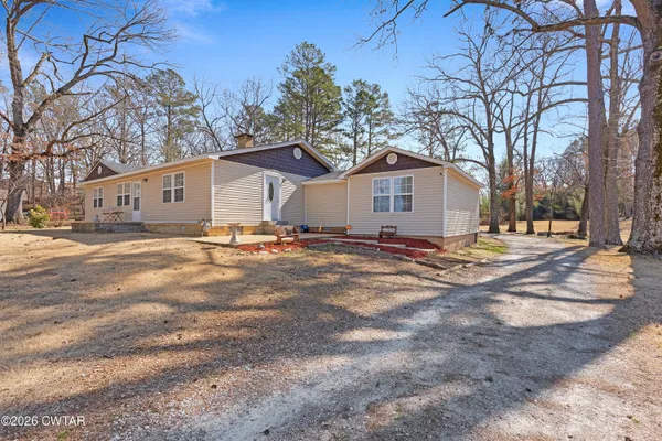 a view of a house with a yard covered in snow