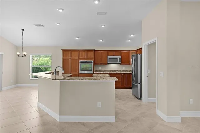 a view of a kitchen with refrigerator and a sink