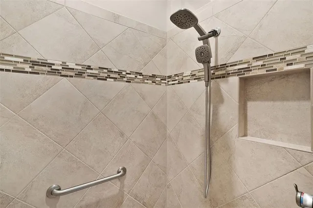 a view of an empty room and a ceiling fan