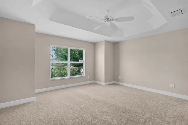 a view of room with window and ceiling fan