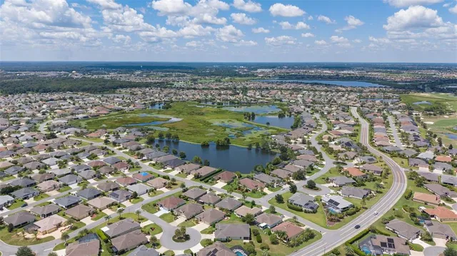 an aerial view of a house with a swimming pool yard and outdoor seating