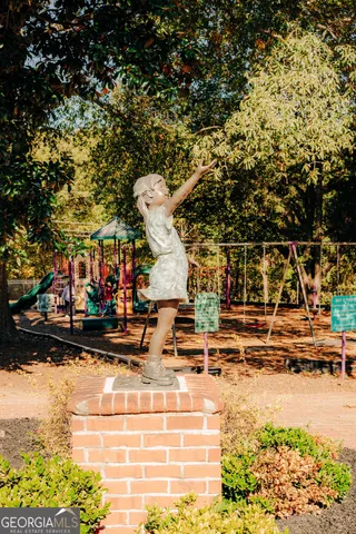 a view of swimming pool with outdoor seating and house in the background