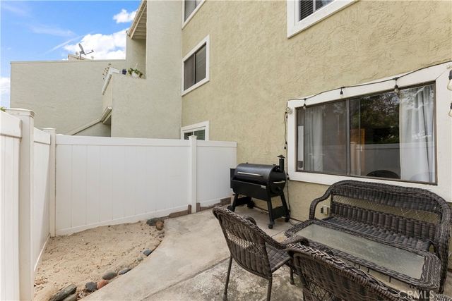 a view of a house with backyard and sitting area