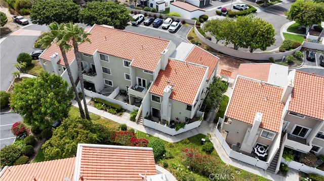an aerial view of a house with garden space and street view