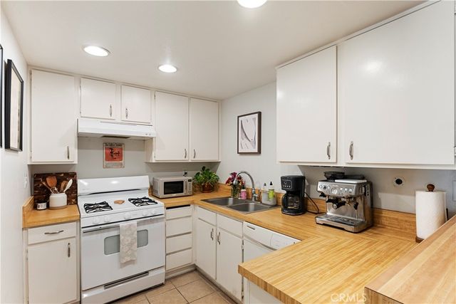 a kitchen with granite countertop a stove and cabinets