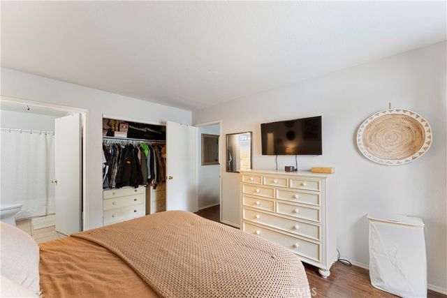 a bedroom with a bed and a flat screen tv