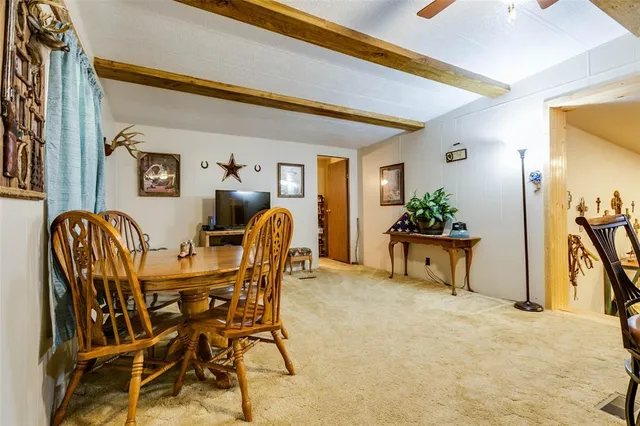 a dining room filled chandelier and wooden furniture