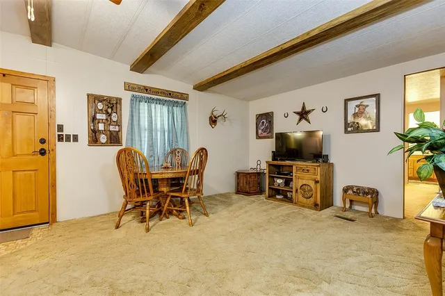 a view of a livingroom with furniture and a flat screen tv