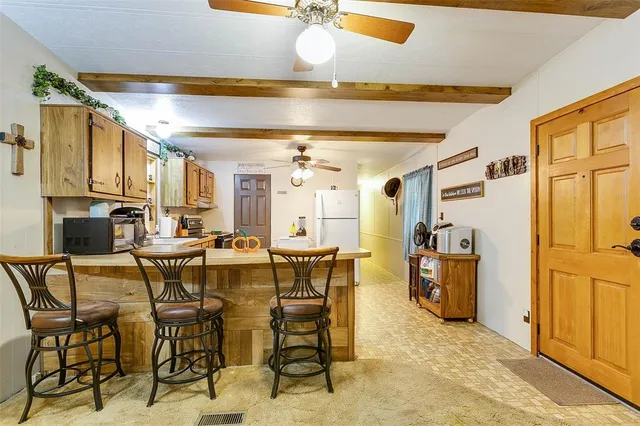 a view of a dining room with furniture and a chandelier