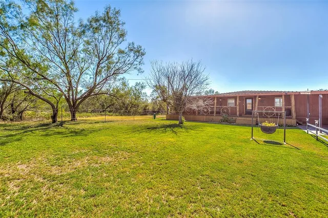 a view of swimming pool with outdoor seating and yard