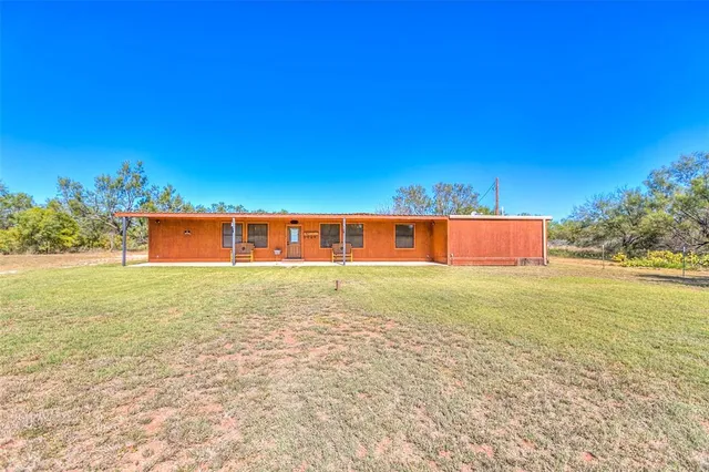 a view of a swimming pool and a yard