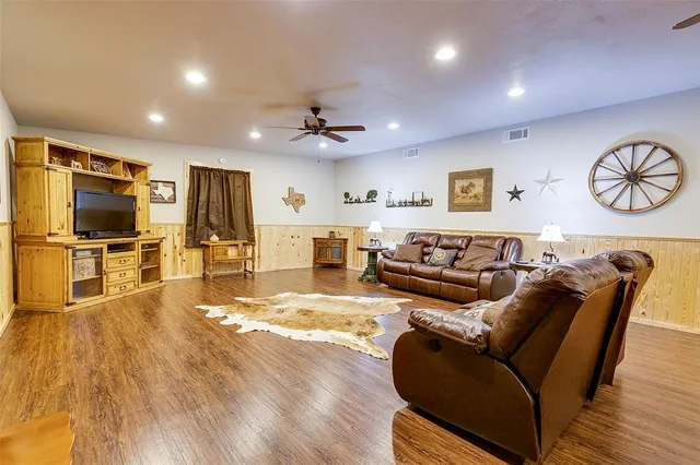 a living room with furniture and kitchen view