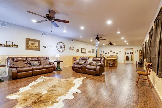 a living room with furniture and wooden floor