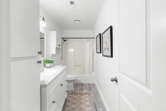 a bedroom with a bed and a painting on the wall