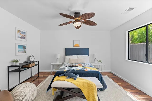 a view of a livingroom with wooden floor and a flat screen tv
