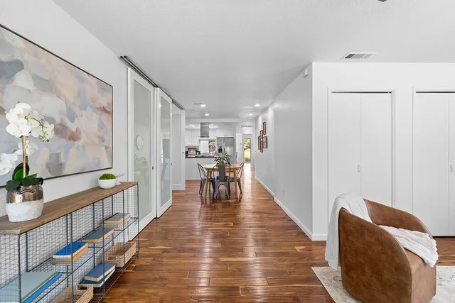 a dining room with furniture and wooden floor