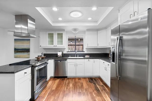 a view of a room with wooden floor