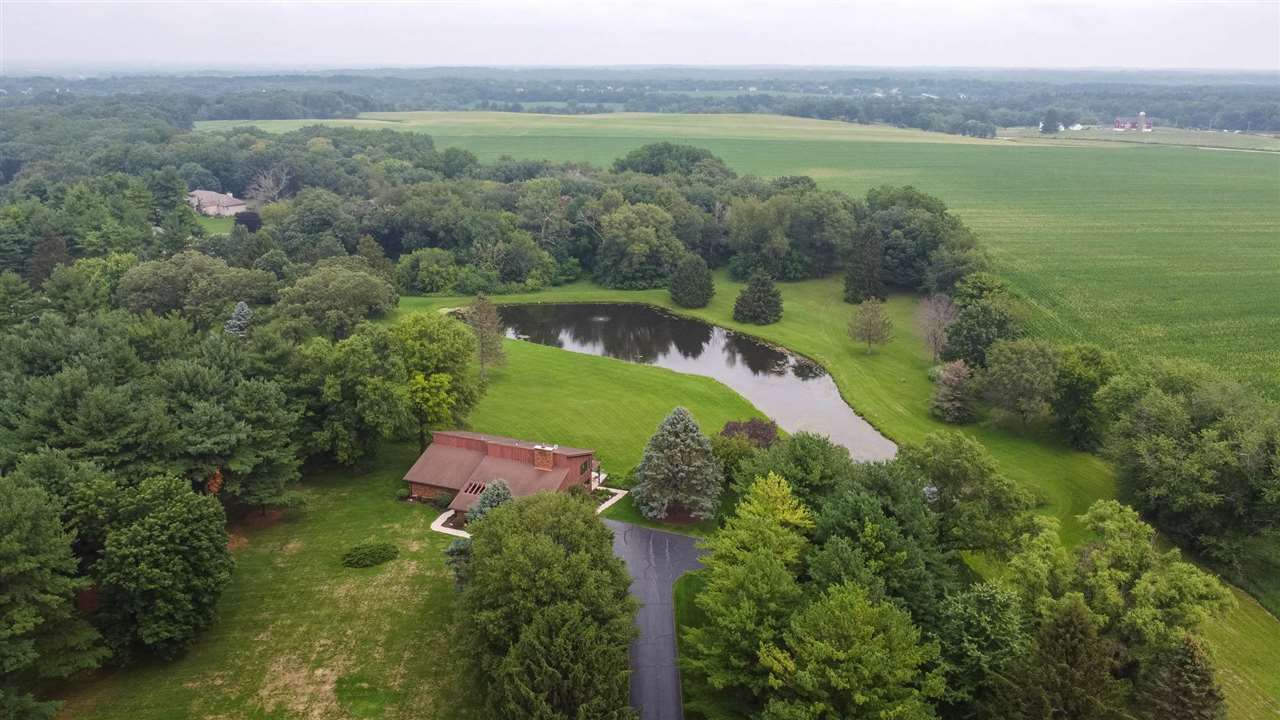 7676 Swanson Road Roscoe, IL 61073 - Photo 1 of 39 a view of a lake with a mountain