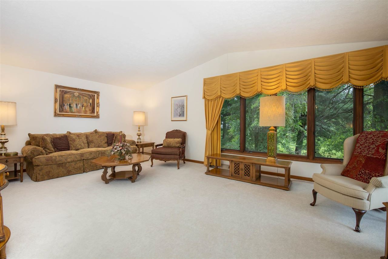 7676 Swanson Road Roscoe, IL 61073 - Photo 11 of 39 a living room with furniture and a floor to ceiling window