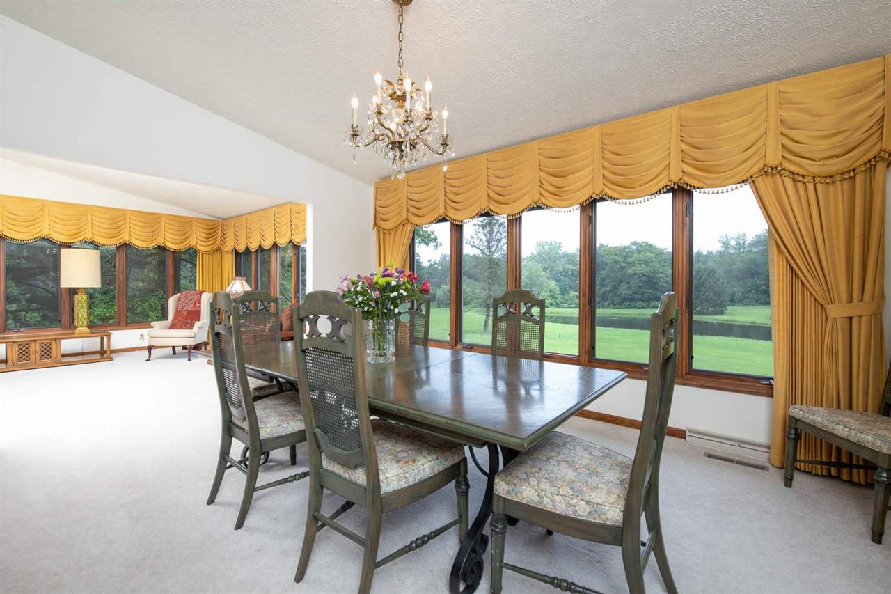 7676 Swanson Road Roscoe, IL 61073 - Photo 13 of 39 a dining room with furniture a chandelier and pool table