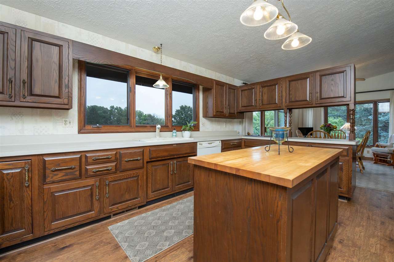 7676 Swanson Road Roscoe, IL 61073 - Photo 15 of 39 a kitchen with a stove a sink and a cabinets