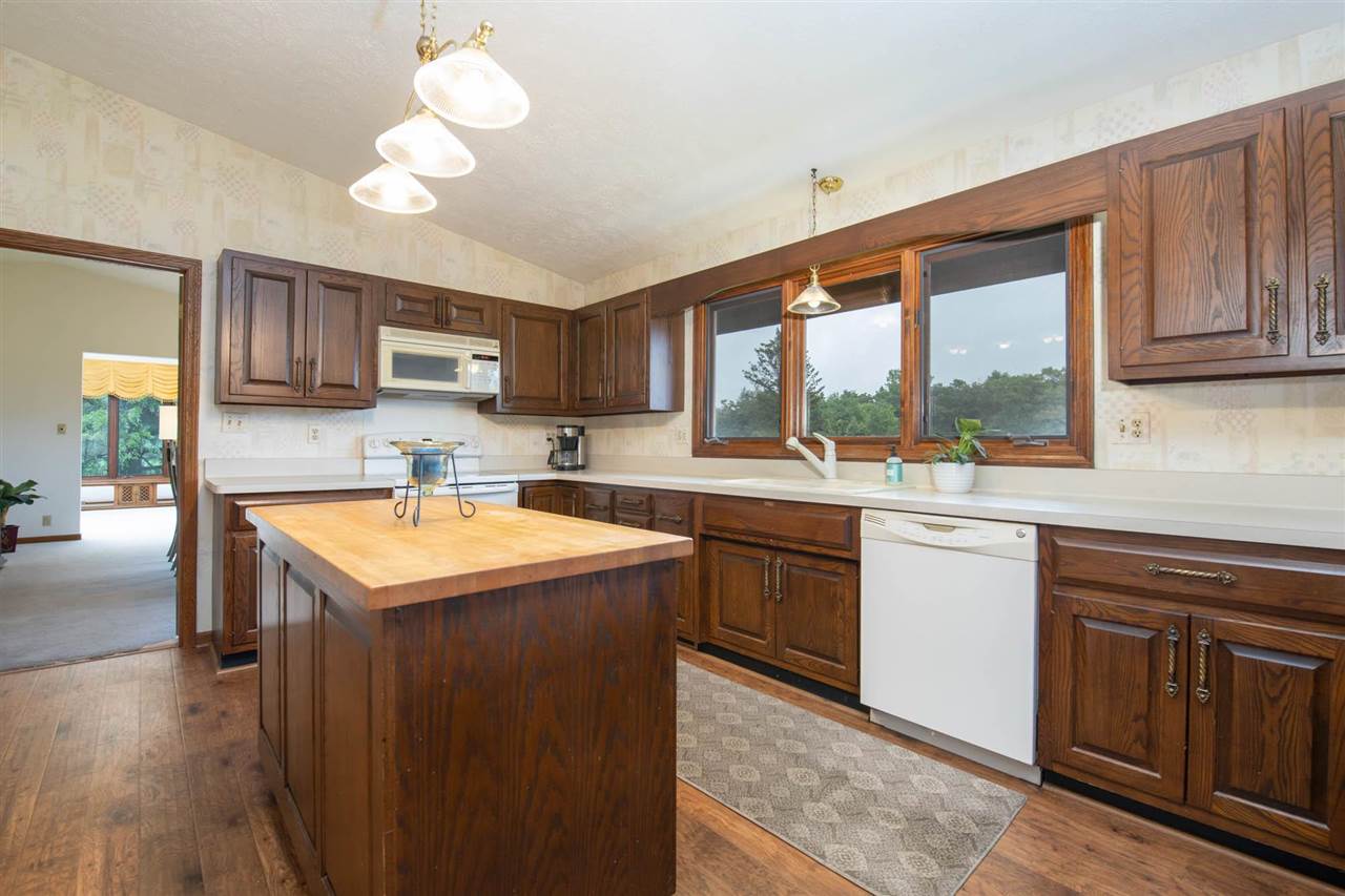 7676 Swanson Road Roscoe, IL 61073 - Photo 17 of 39 a kitchen with a sink stove and cabinets
