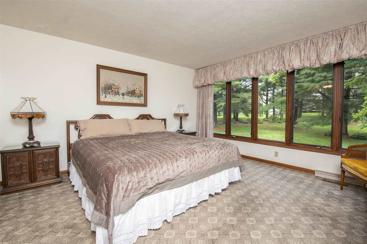 7676 Swanson Road Roscoe, IL 61073 - Photo 21 of 39 a spacious bedroom with a large bed and a large window