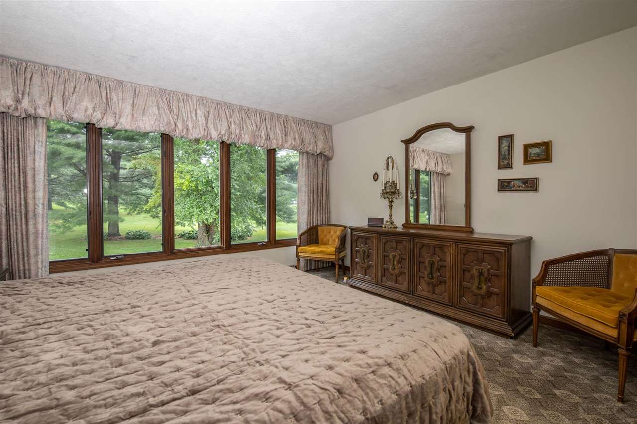 7676 Swanson Road Roscoe, IL 61073 - Photo 22 of 39 a bed room with a bed and a chair