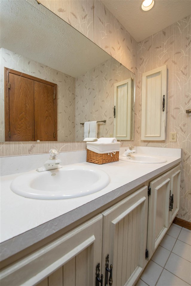 7676 Swanson Road Roscoe, IL 61073 - Photo 23 of 39 a bathroom with a sink and a mirror
