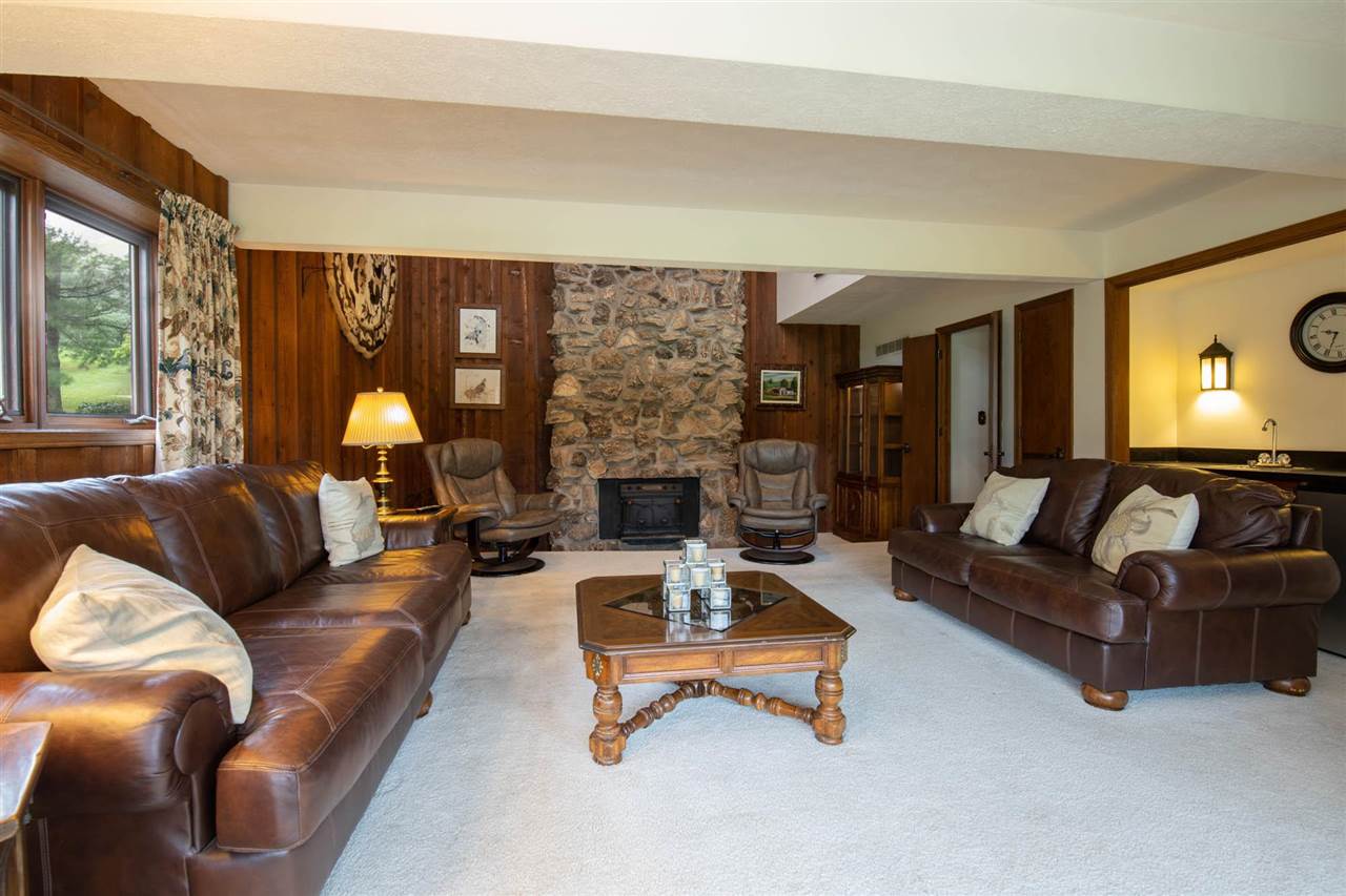 7676 Swanson Road Roscoe, IL 61073 - Photo 26 of 39 a living room with furniture and a fireplace