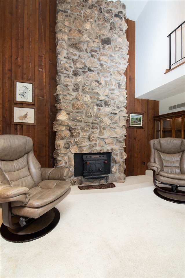 7676 Swanson Road Roscoe, IL 61073 - Photo 27 of 39 a living room with furniture and a fireplace